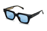 Ming square frame at three-quarter angle in black acetate with thick profile and light blue lenses