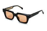 Angled view of Ming in chunky black acetate showing square frame depth and amber tinted lenses