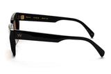 Side profile of Renae frame showing black acetate temple with gold AM crown logo and hinge detail